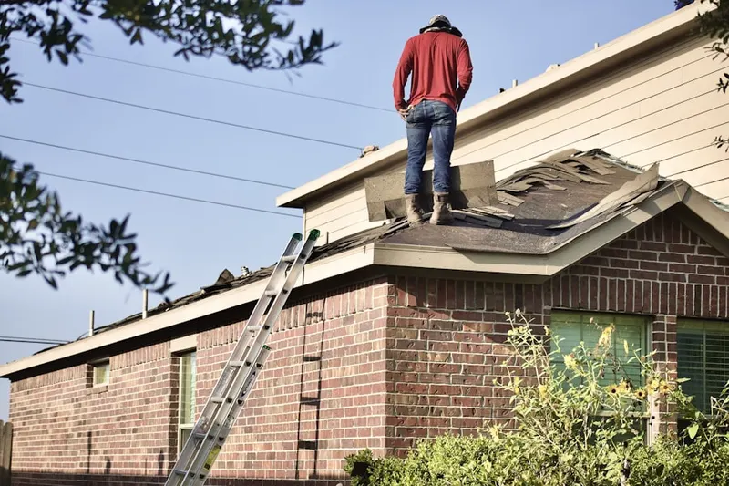 Professional roofer working on a residential roof in Pinehurst